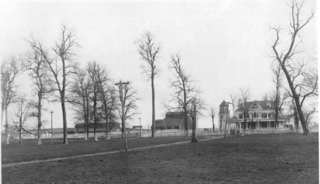 Black-and-white photograph of the Meadowthorpe farm property, showing the main house, outbuildings, trees, and open ground later used for Halley Field.